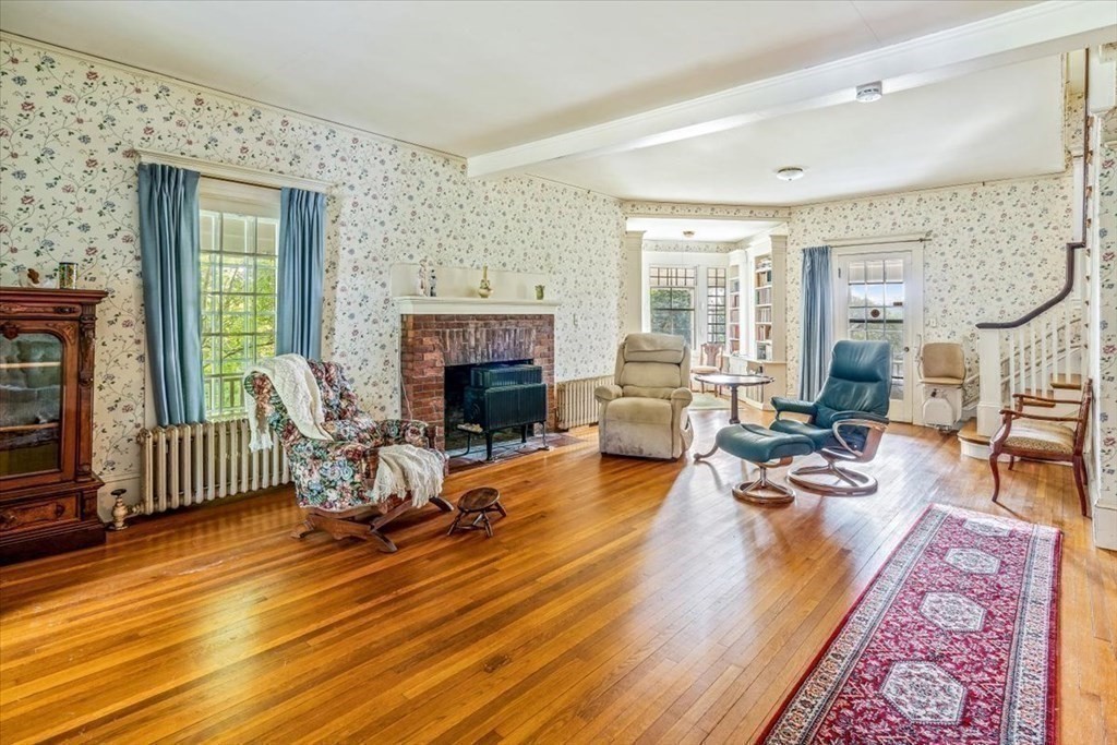 48 Neal Gate Street Scituate, MA 02066 - Photo 9 of 34 a living room with furniture and a fireplace