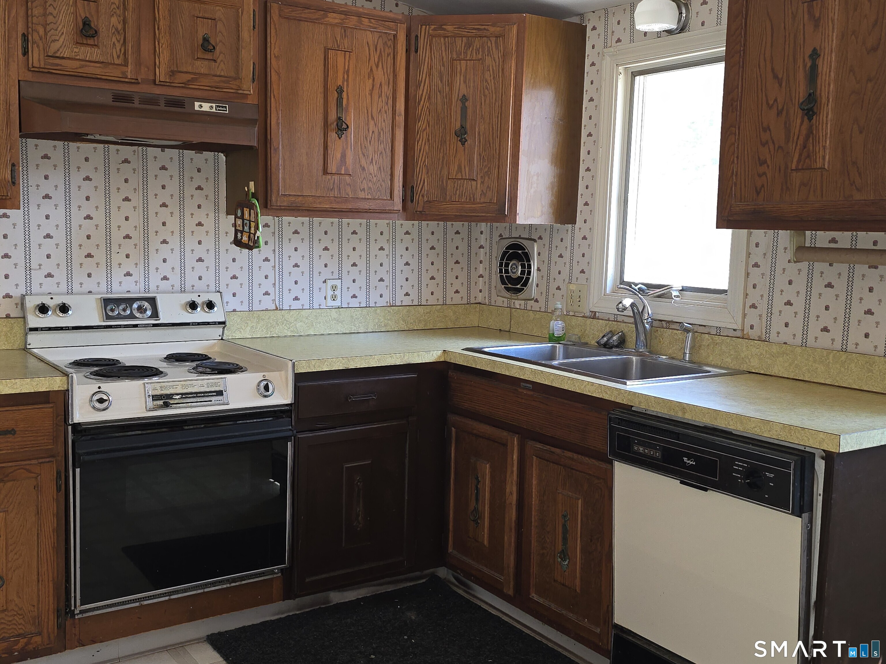34 Country Club Drive Ledyard, CT 06339 - Photo 6 of 21 a kitchen with a sink stove and cabinets