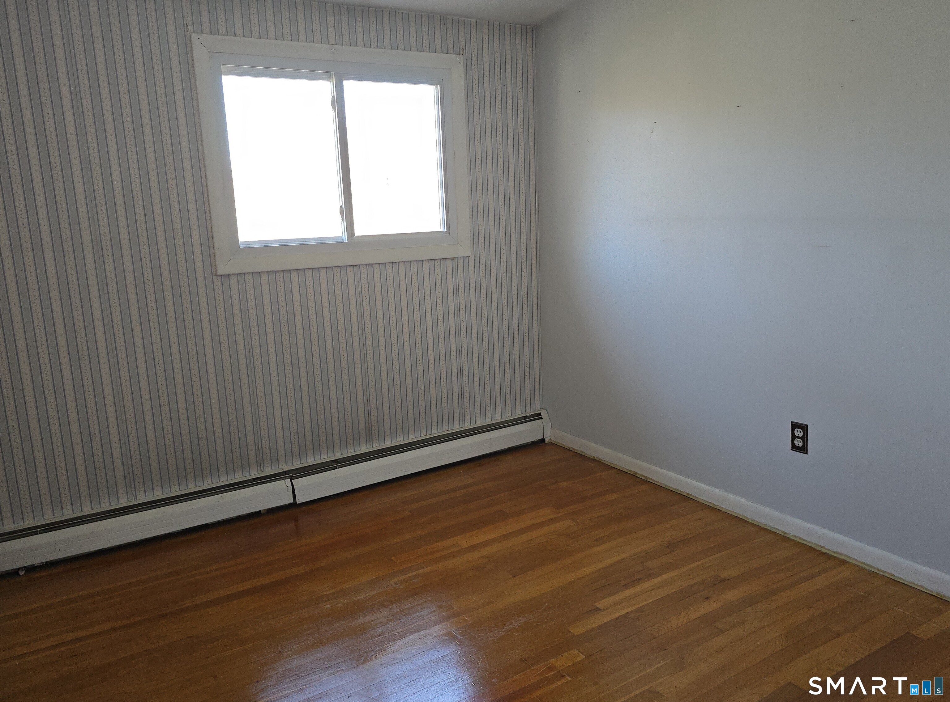 34 Country Club Drive Ledyard, CT 06339 - Photo 9 of 21 an empty room with wooden floor and windows