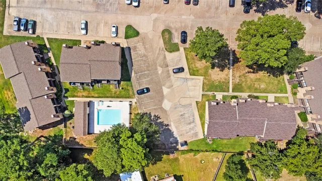 an aerial view of residential houses with outdoor space and street view