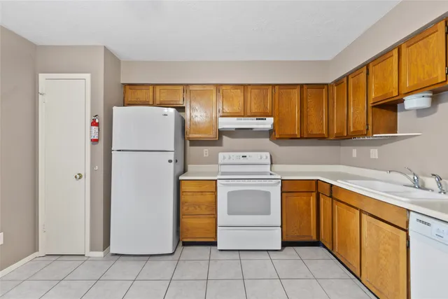 a utility room with cabinets washer and dryer