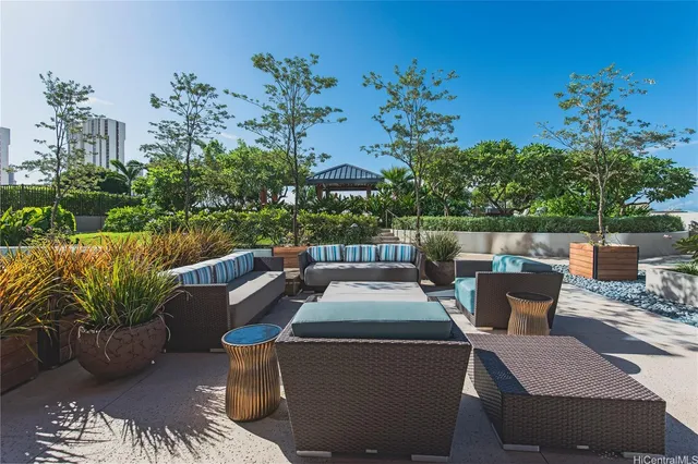 a view of a patio with couches table and chairs and potted plants