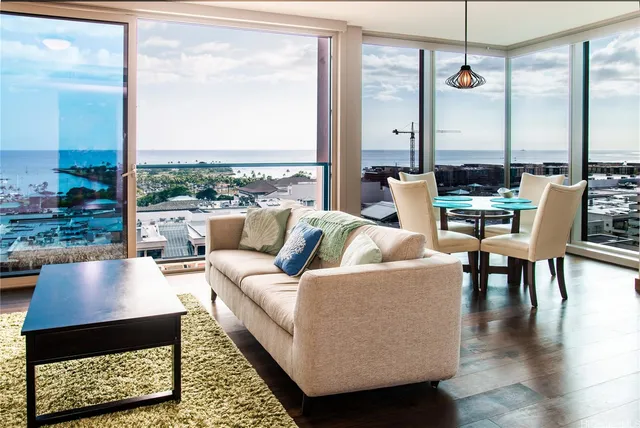 a living room with patio furniture and a large window