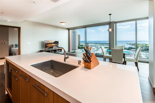 a view of living room with furniture and large windows