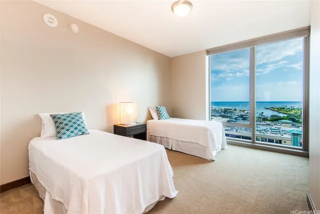 a bedroom with two beds and a large window