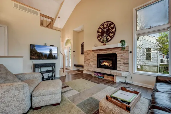 a living room with furniture a flat screen tv and a fireplace