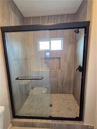 a bathroom with a glass shower door