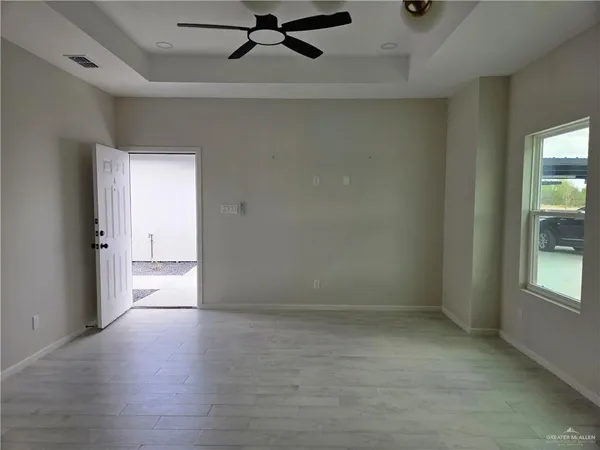 an empty room with a empty space and windows