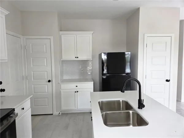 a kitchen with a sink and a refrigerator
