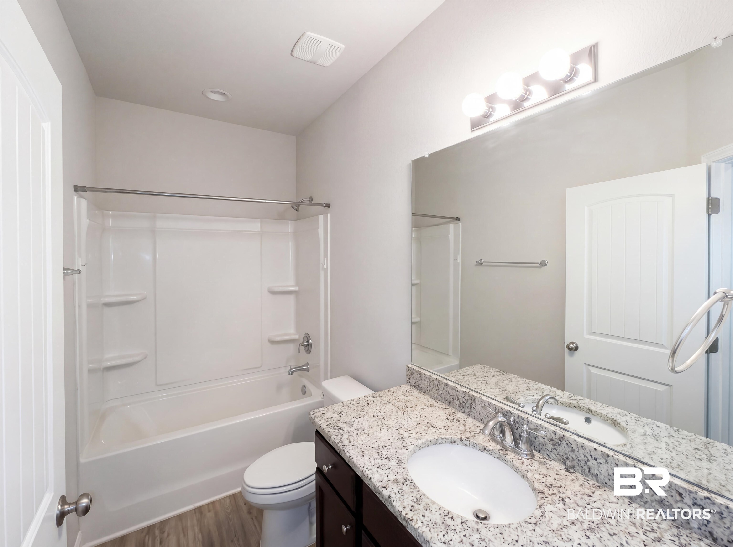 1740 Covington Lane Foley, AL 36535 - Photo 10 of 18 Bathroom featuring a full vanity with granite-style countertop, undermount sink, and dark wood-finish cabinetry