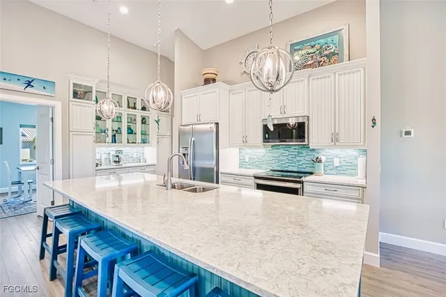 a kitchen with stainless steel appliances granite countertop a stove and cabinets
