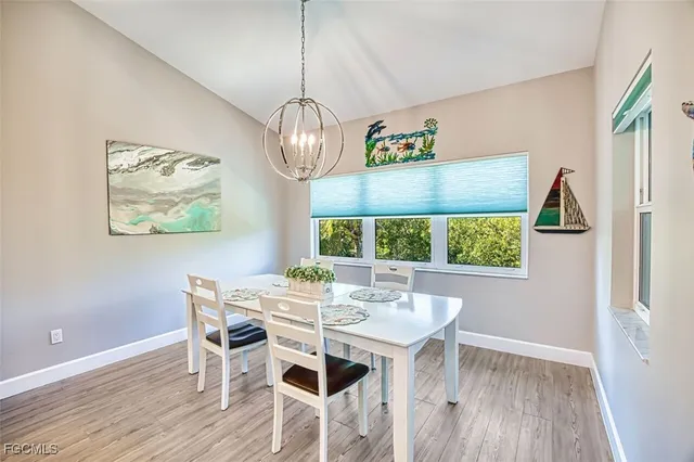 a view of a dining room with furniture wooden floor and chandelier