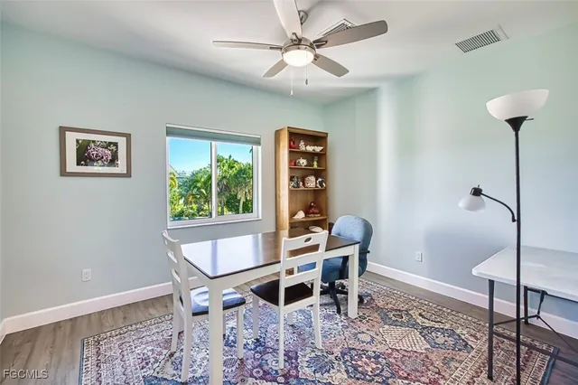 a view of a dining room with furniture and a window