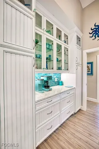 a view of a dresser with wooden floor and cabinet