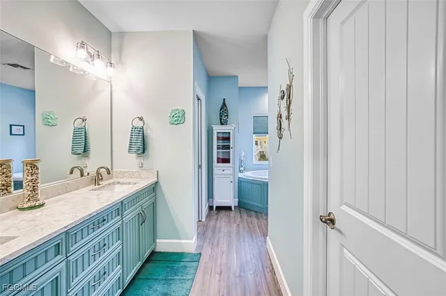 a bathroom with a double vanity sink a mirror and a shower