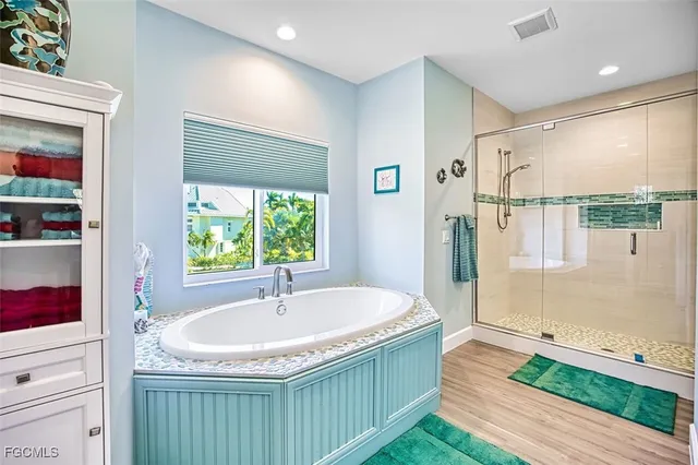 a bathroom with a granite countertop sink a mirror and shower
