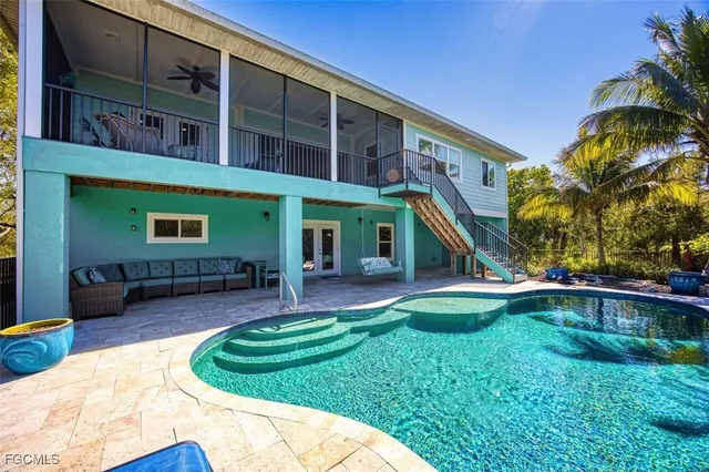 a view of a house with a yard patio and swimming pool