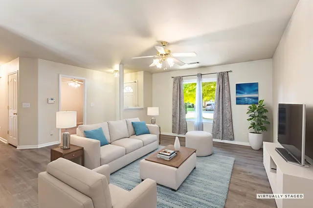 a living room with furniture and a flat screen tv