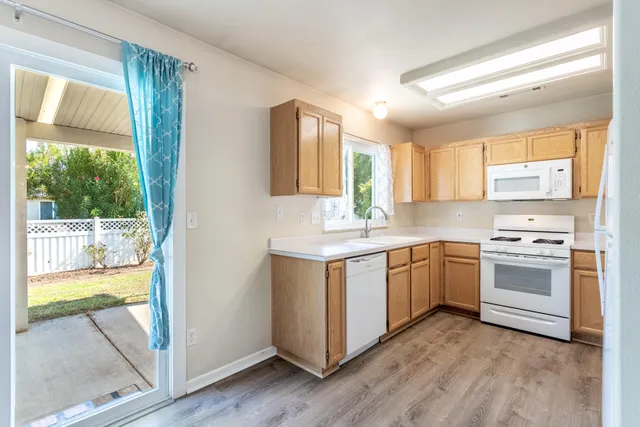 a kitchen with a sink window and cabinets
