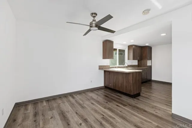 a kitchen with a sink cabinets and wooden floor