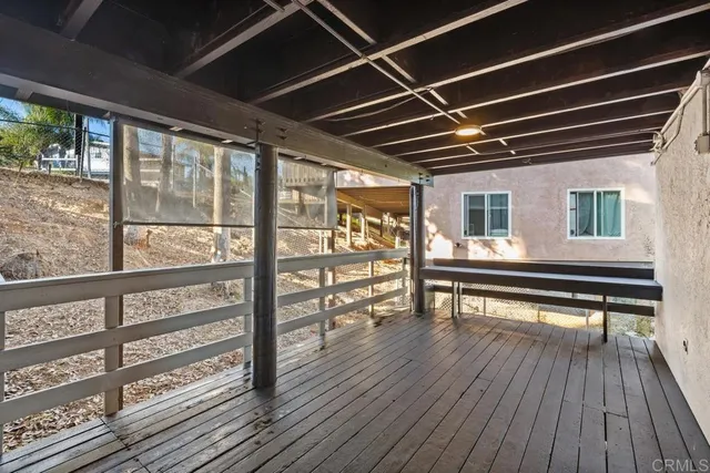 a view of a porch with wooden floor and iron stairs