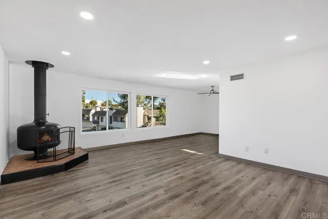 a view of a room with wooden floor and a window