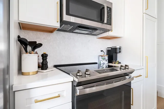 a kitchen with a stove and a microwave