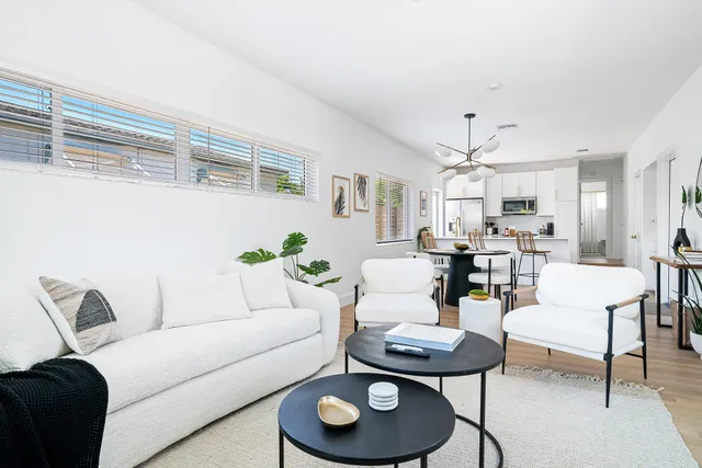 a living room with furniture and a dining table
