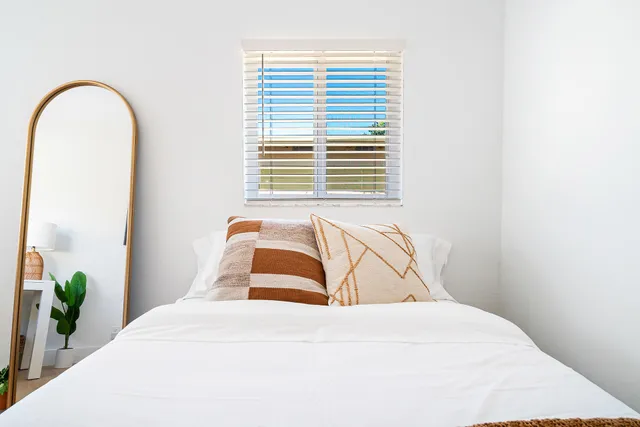 a bedroom with a bed and a window