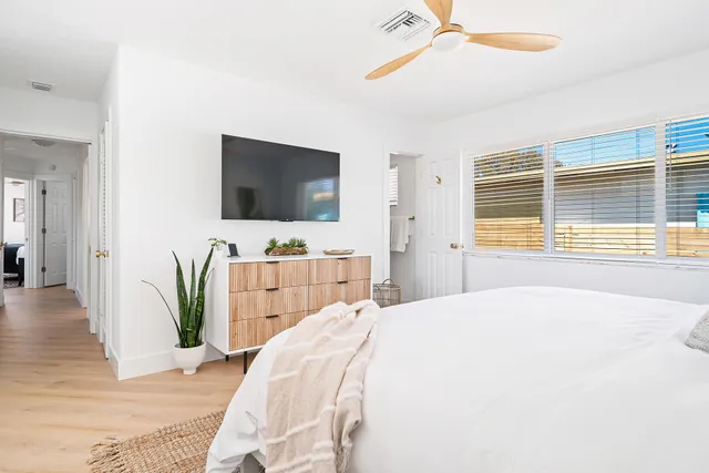 a bedroom with a bed and a flat screen tv