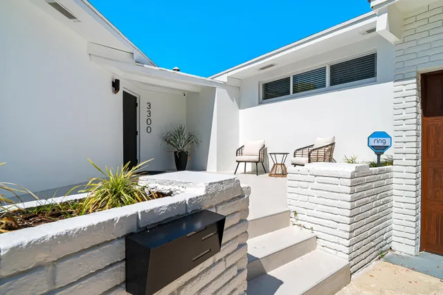 a view of front door and potted plants