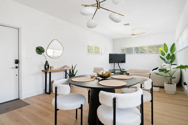 a view of a dining room with furniture and wooden floor