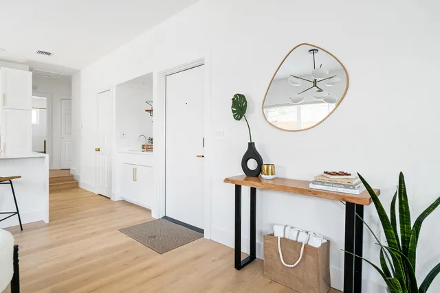 a view of a room with wooden floor and white walls