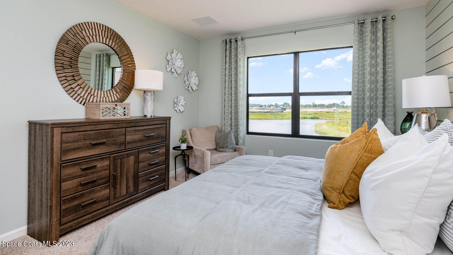 7108 Mooring Way Grant-Valkaria, FL 32949 - Photo 11 of 33 a bedroom with a bed a dresser and a window