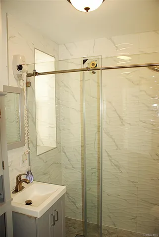 a bathroom with a sink a toilet a mirror and shower