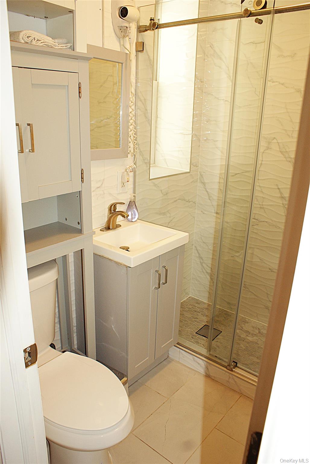 600 Flatbush Avenue Brooklyn, NY 11225 - Photo 15 of 17 Full bathroom featuring vanity, light tile patterned floors, and a stall shower