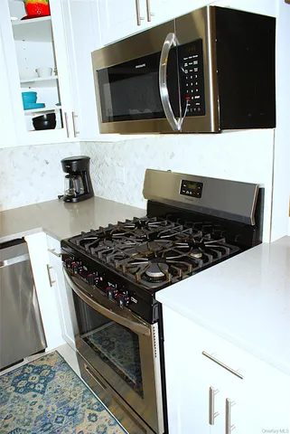 a kitchen with stove and cabinets