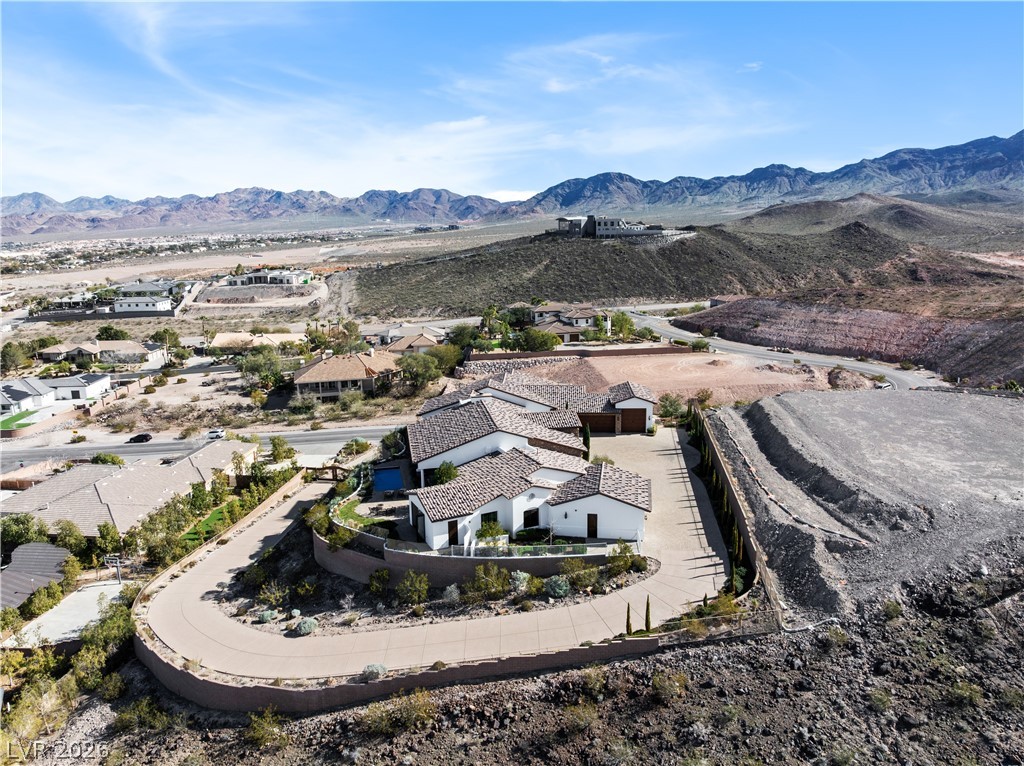 1123 Christian Road Henderson, NV 89002 - Photo 87 of 94 An aerial panorama reveals a magnificent home nestled against dramatic mountain scenery.