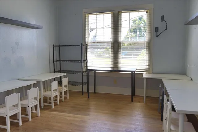 a view of a dining room with furniture and wooden floor