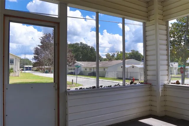a room with a floor to ceiling window and an outdoor view