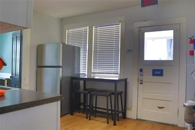 a kitchen with a refrigerator and window