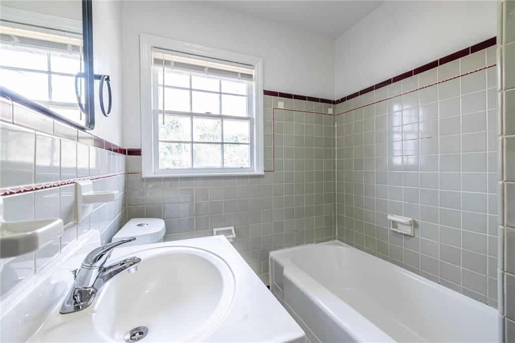 2986 Belvedere Lane Decatur, GA 30032 - Photo 13 of 18 a bathroom with a sink a bathtub and window