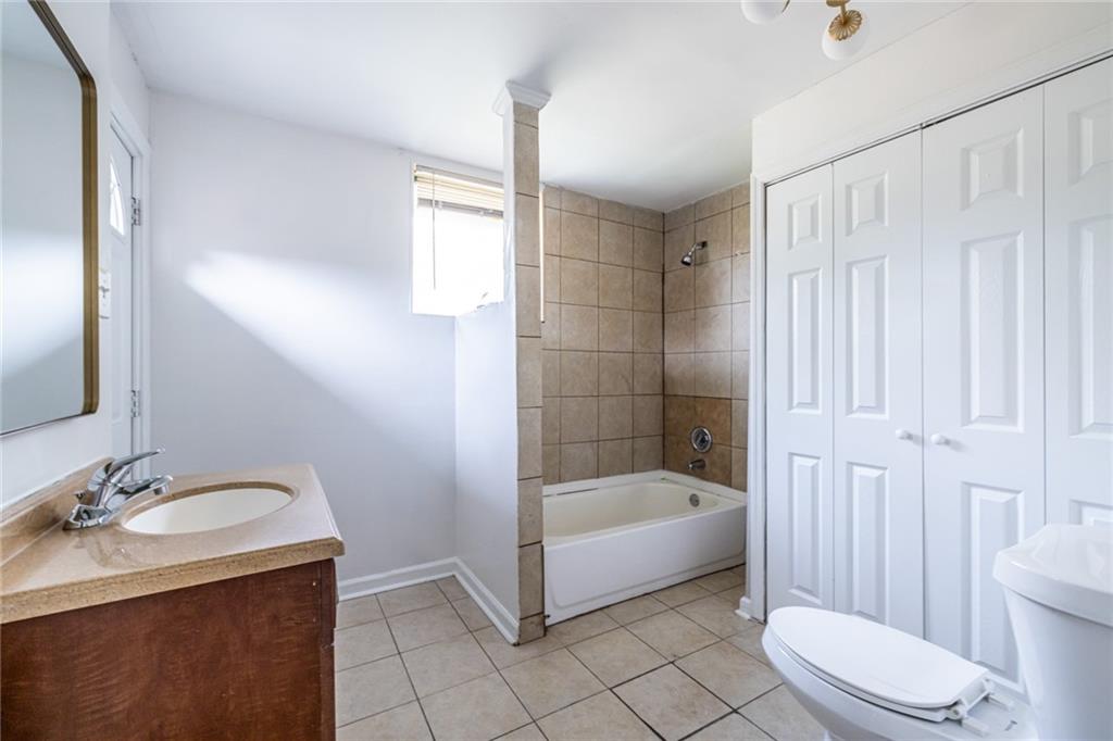 2986 Belvedere Lane Decatur, GA 30032 - Photo 15 of 18 a bathroom with a sink a toilet and shower