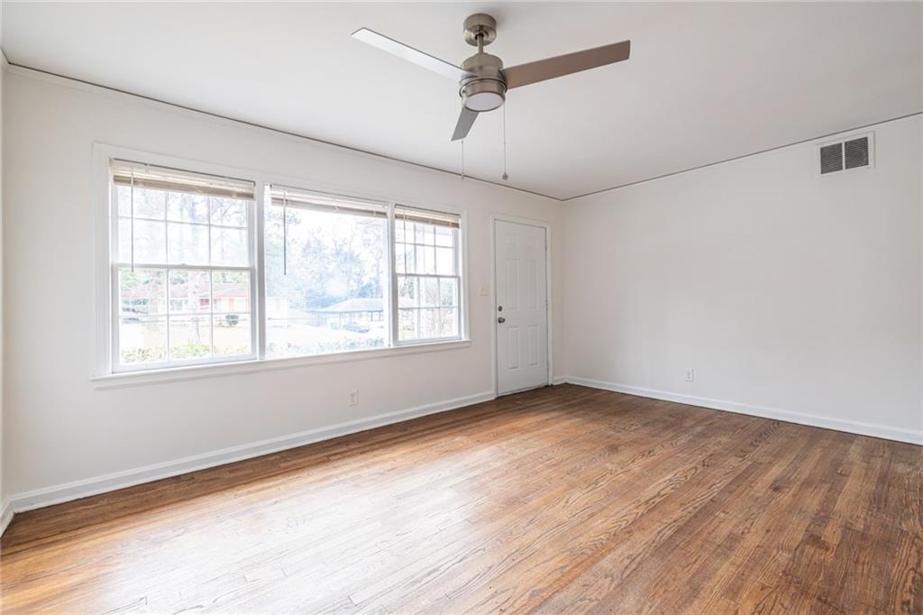 2986 Belvedere Lane Decatur, GA 30032 - Photo 4 of 18 a view of an empty room with wooden floor and a window