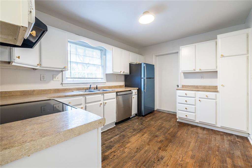 2986 Belvedere Lane Decatur, GA 30032 - Photo 5 of 18 a kitchen with granite countertop a sink appliances cabinets and counter space
