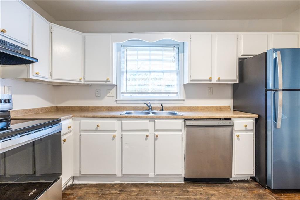 2986 Belvedere Lane Decatur, GA 30032 - Photo 7 of 18 a kitchen with white cabinets and white appliances