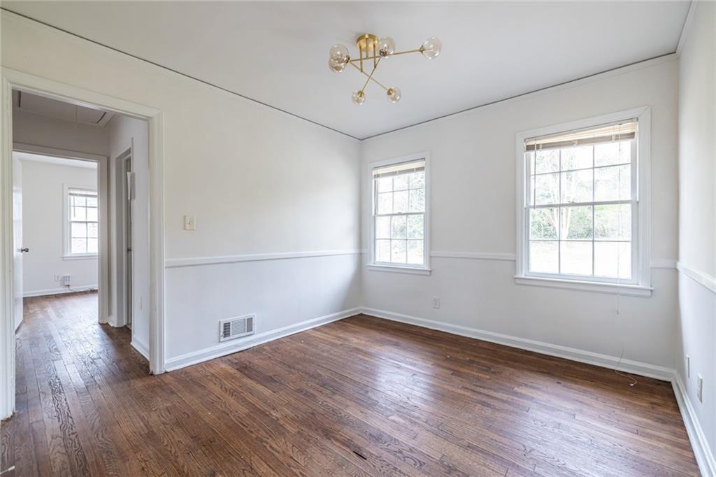 2986 Belvedere Lane Decatur, GA 30032 - Photo 8 of 18 an empty room with wooden floor and windows