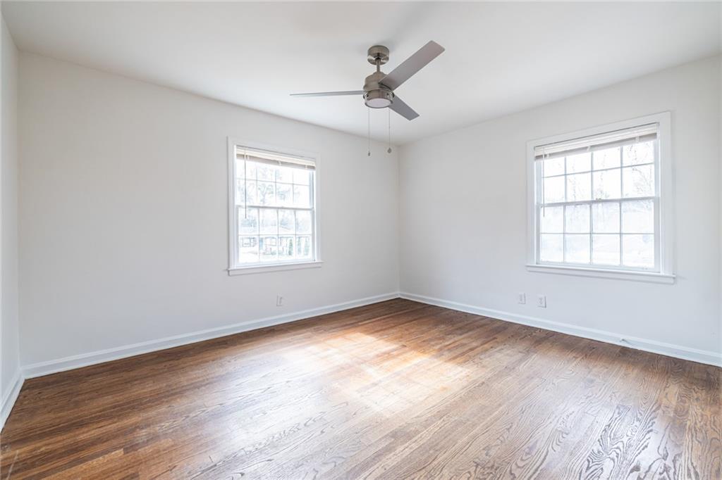 2986 Belvedere Lane Decatur, GA 30032 - Photo 9 of 18 a view of an empty room with wooden floor and a window