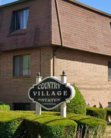 a view of brick wall of building and small pool