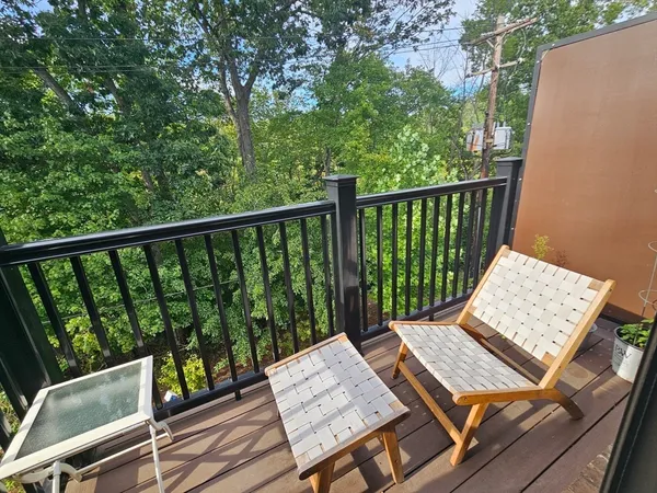 a view of a balcony with wooden floor